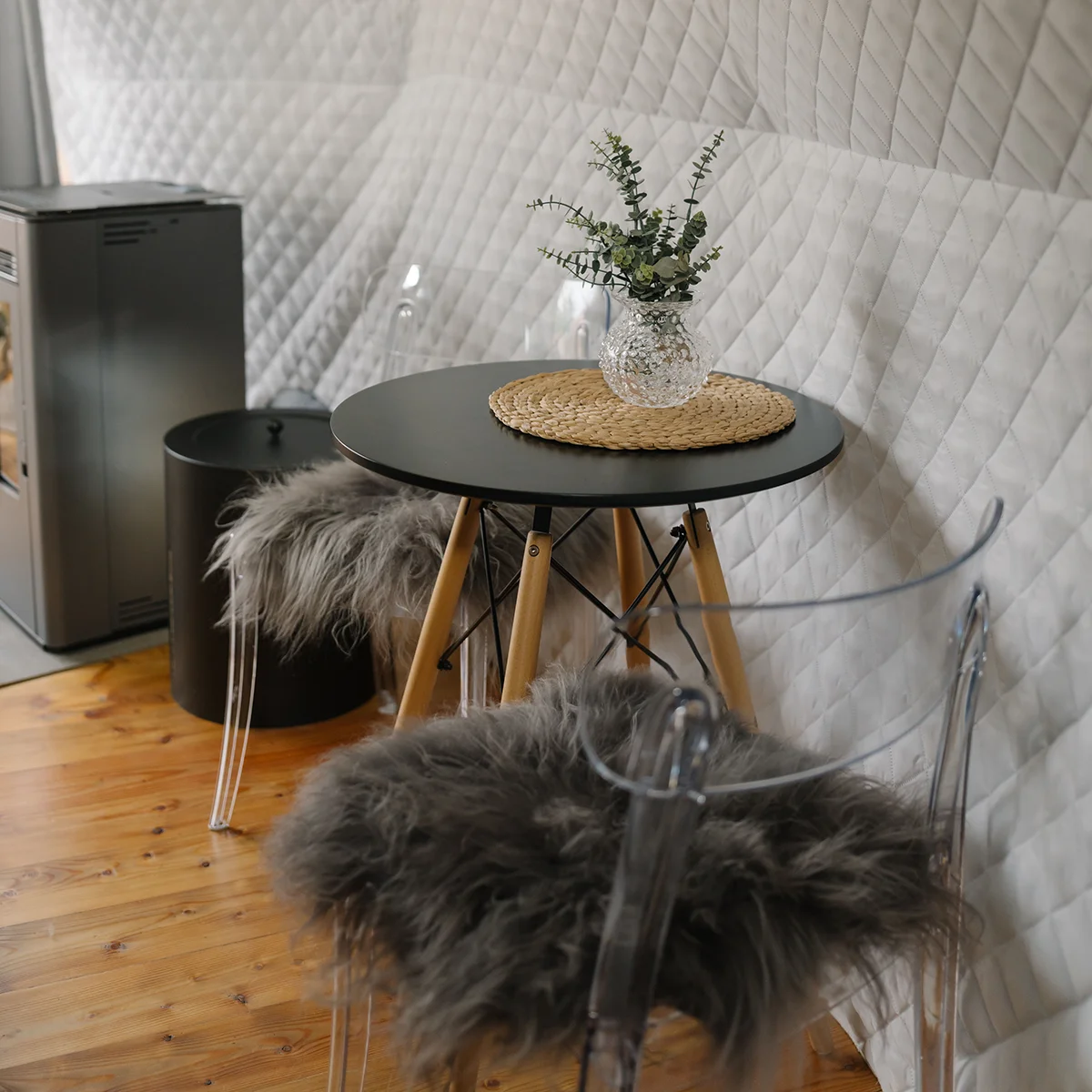 Morning inside the dome — knit blanket on the sofa, light through the glass panels